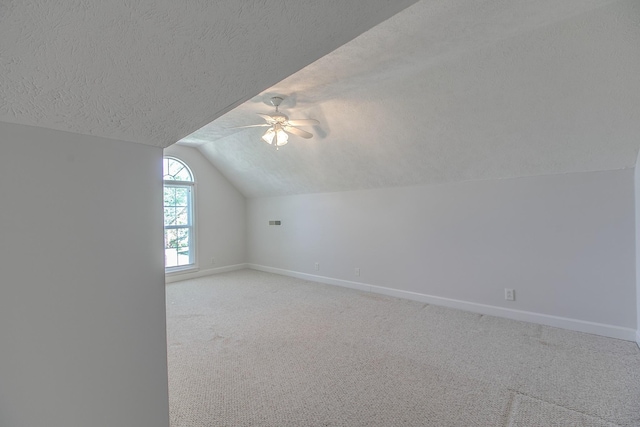 206 Sayre Ln, Murfreesboro, TN 37127 - additional living space featuring baseboards, vaulted ceiling, ceiling fan, a textured ceiling, and light carpet