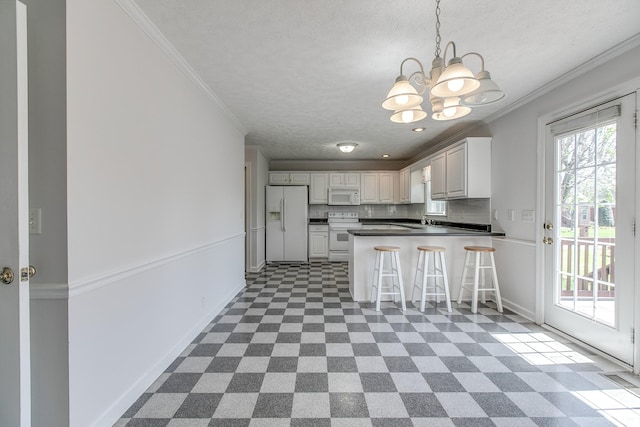 206 Sayre Ln, Murfreesboro, TN 37127 - kitchen with white appliances, a chandelier, a textured ceiling, a peninsula, and dark countertops