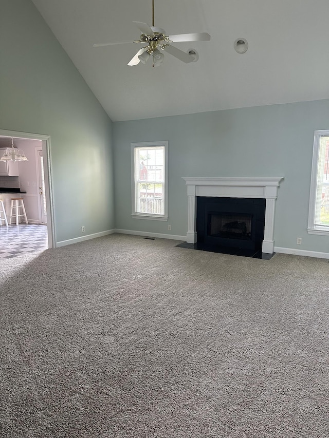 206 Sayre Ln, Murfreesboro, TN 37127 - unfurnished living room featuring high vaulted ceiling, a fireplace with flush hearth, baseboards, ceiling fan, and carpet floors