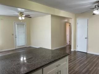 904 Apple Valley Rd, Madison, TN 37115 - kitchen with ceiling fan, white cabinets, baseboards, dark stone countertops, and dark wood-style flooring