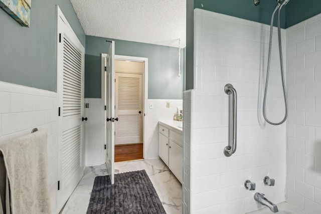 979 S Main St S, Eagleville, TN 37060 - bathroom with tile walls,  shower combination, wainscoting, vanity, and marble finish floors