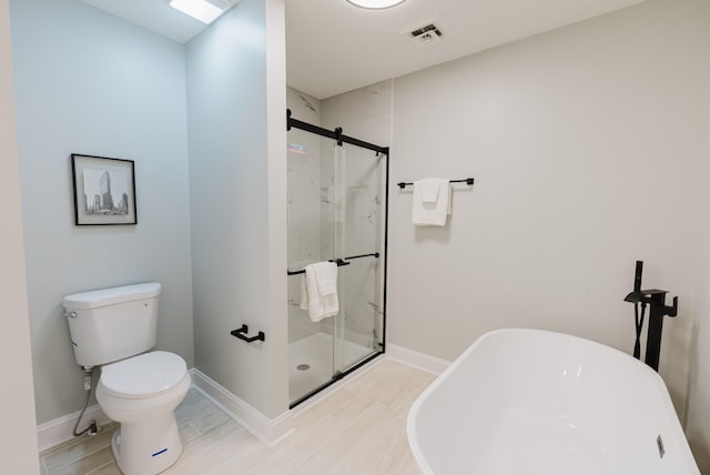 1405 SE Broad St, Murfreesboro, TN 37130 - full bathroom featuring a freestanding bath, a marble finish shower, toilet, and wood finished floors