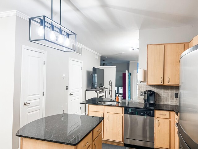 1803 Broadway Unit 509, Nashville, TN 37203 - kitchen featuring appliances with stainless steel finishes, light brown cabinets, a sink, and ornamental molding