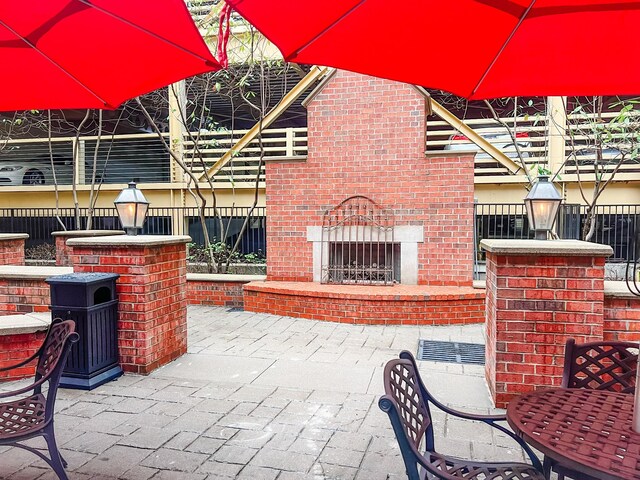1803 Broadway Unit 509, Nashville, TN 37203 - view of patio / terrace featuring an outdoor brick fireplace and outdoor dining space