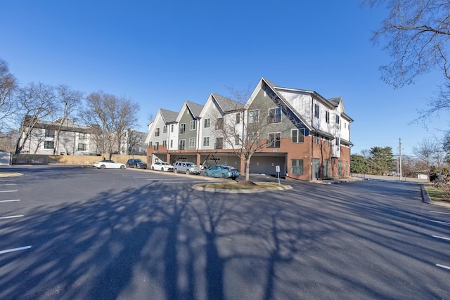 4303 Gallatin Pike Unit 206, Nashville, TN 37216 - view of property exterior featuring a residential view, uncovered parking, and stucco siding
