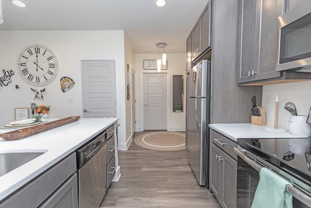 4303 Gallatin Pike Unit 206, Nashville, TN 37216 - kitchen with appliances with stainless steel finishes, wood finished floors, light countertops, gray cabinetry, and recessed lighting