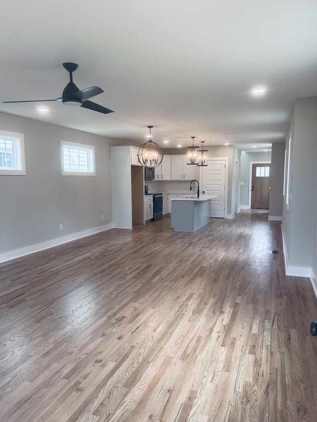 5930 Carl Pl, Nashville, TN 37209 - unfurnished living room with a chandelier, dark wood finished floors, baseboards, a ceiling fan, and recessed lighting