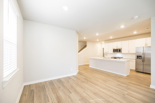 441 Golden Meadow Ln, Hendersonville, TN 37075 - kitchen featuring appliances with stainless steel finishes, baseboards, light wood finished floors, white cabinets, and recessed lighting