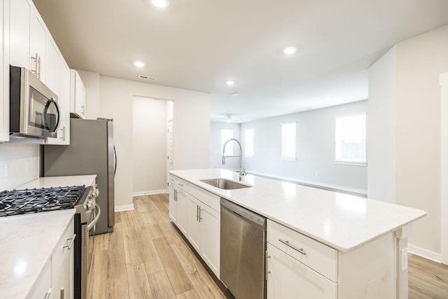 441 Golden Meadow Ln, Hendersonville, TN 37075 - kitchen with stainless steel appliances, a sink, a kitchen island with sink, light wood-style floors, and white cabinetry