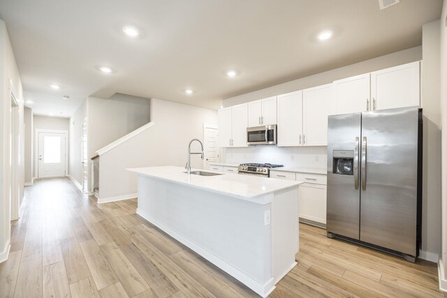 441 Golden Meadow Ln, Hendersonville, TN 37075 - kitchen featuring appliances with stainless steel finishes, a sink, white cabinets, an island with sink, and light countertops