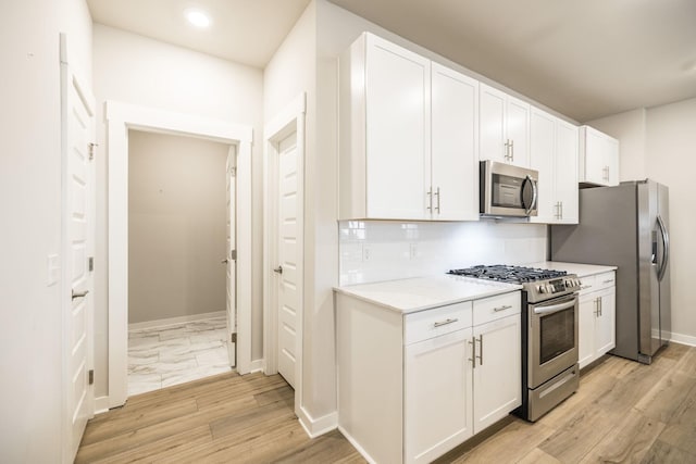 441 Golden Meadow Ln, Hendersonville, TN 37075 - kitchen featuring appliances with stainless steel finishes, light countertops, tasteful backsplash, white cabinetry, and baseboards