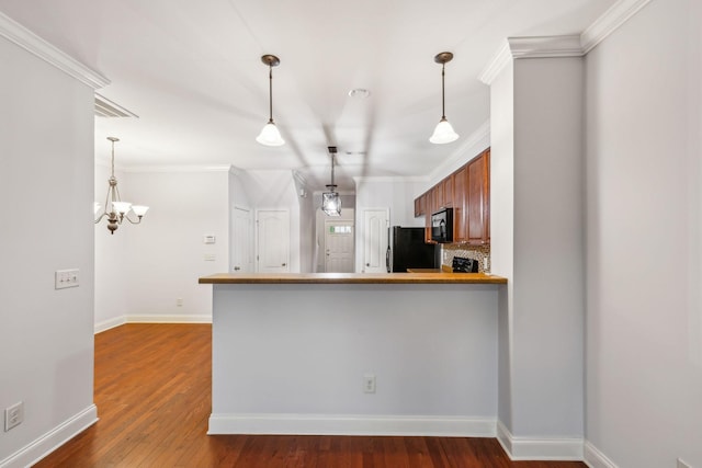 735 Tulip Grove Rd Unit 325, Hermitage, TN 37076 - kitchen featuring black appliances, crown molding, a chandelier, decorative light fixtures, and dark wood finished floors