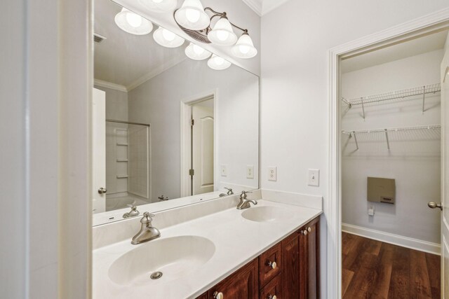 735 Tulip Grove Rd Unit 325, Hermitage, TN 37076 - bathroom with double vanity, crown molding, wood finished floors, a walk in closet, and  shower combination