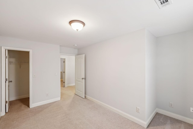 735 Tulip Grove Rd Unit 325, Hermitage, TN 37076 - unfurnished bedroom featuring light colored carpet, a spacious closet, baseboards, and a closet