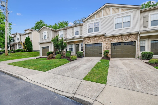 735 Tulip Grove Rd Unit 325, Hermitage, TN 37076 - view of property featuring concrete driveway, a front lawn, a residential view, a garage, and stone siding