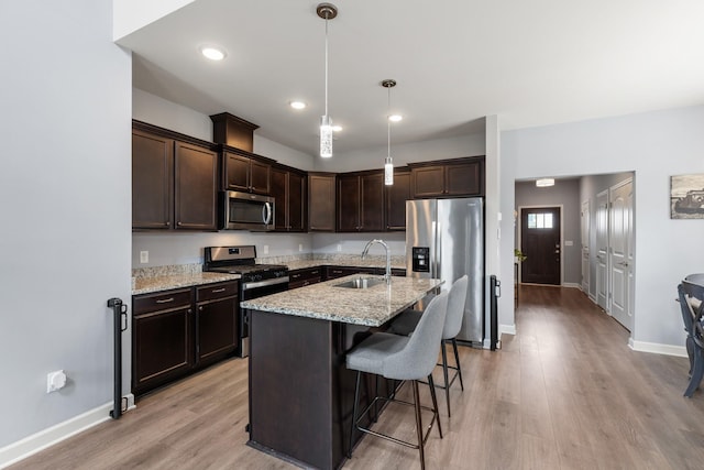 1339 Raden Dr, Lebanon, TN 37087 - kitchen featuring stainless steel appliances, a sink, dark brown cabinets, light stone counters, and recessed lighting
