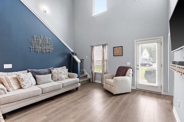 1339 Raden Dr, Lebanon, TN 37087 - living room with a high ceiling, stairs, wood finished floors, and baseboards