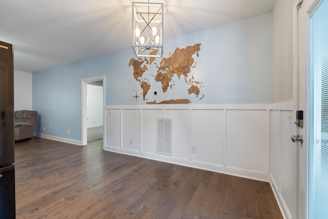 190 Twin Ct, Woodbury, TN 37190 - unfurnished dining area with wood finished floors, a chandelier, wainscoting, and a decorative wall