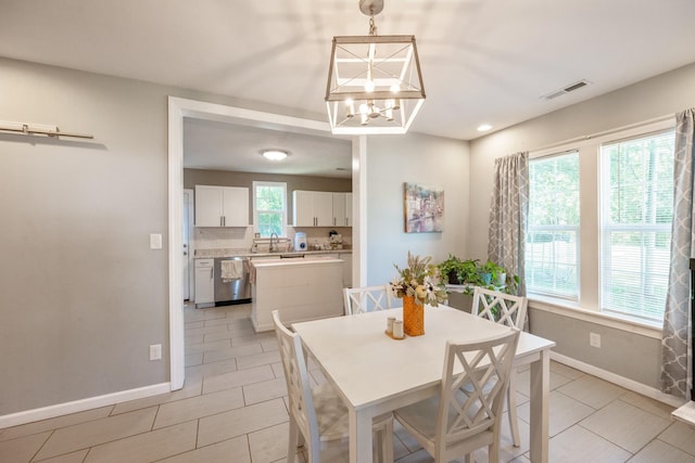318 Church St, Clifton, TN 38425 - dining space featuring baseboards, light tile patterned floors, and a chandelier