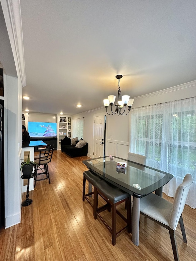 379 Thompson Ln, Tracy City, TN 37387 - dining area with ornamental molding, a chandelier, and wood finished floors