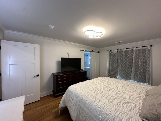 379 Thompson Ln, Tracy City, TN 37387 - bedroom with wood finished floors, ornamental molding, baseboards, and a barn door