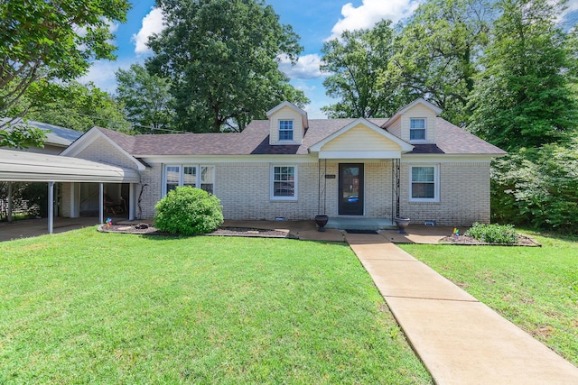 200 N 18th Ave, Humboldt, TN 38343 - cape cod home featuring brick siding, a carport, a front yard, and a shingled roof