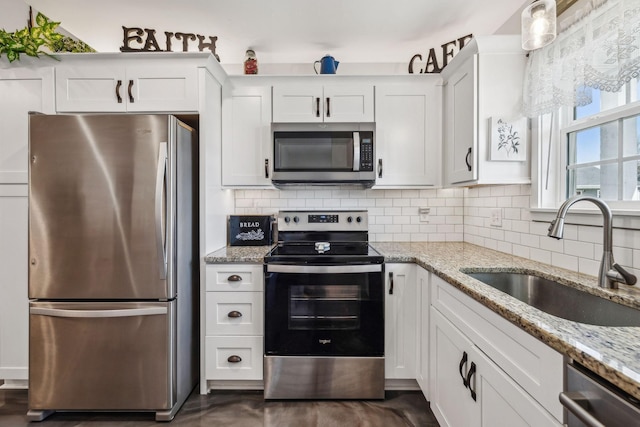 200 Nichols Dr, Woodbury, TN 37190 - kitchen featuring appliances with stainless steel finishes, a sink, white cabinets, and backsplash