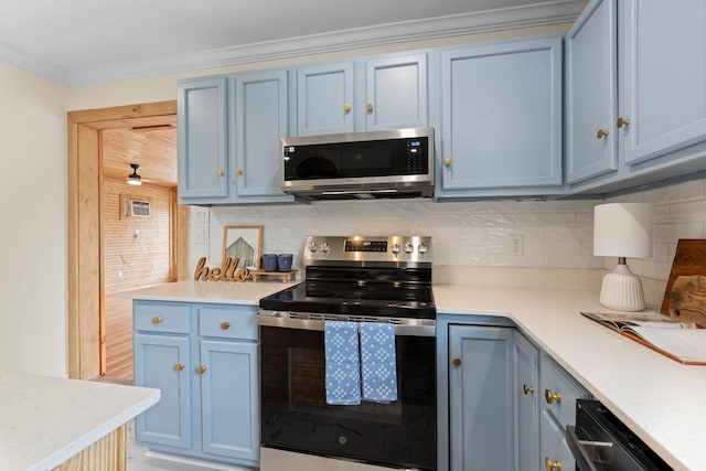 1371 Pomona Rd, Dickson, TN 37055 - kitchen featuring appliances with stainless steel finishes, blue cabinets, backsplash, light countertops, and crown molding