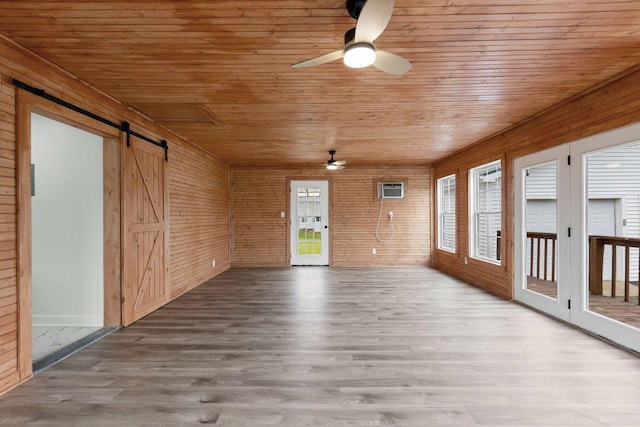 1371 Pomona Rd, Dickson, TN 37055 - unfurnished room featuring a ceiling fan, a barn door, wooden ceiling, wood finished floors, and wood walls