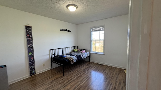 312 Pappy Dr, Oak Grove, KY 42262 - bedroom featuring wood finished floors, a textured ceiling, and baseboards