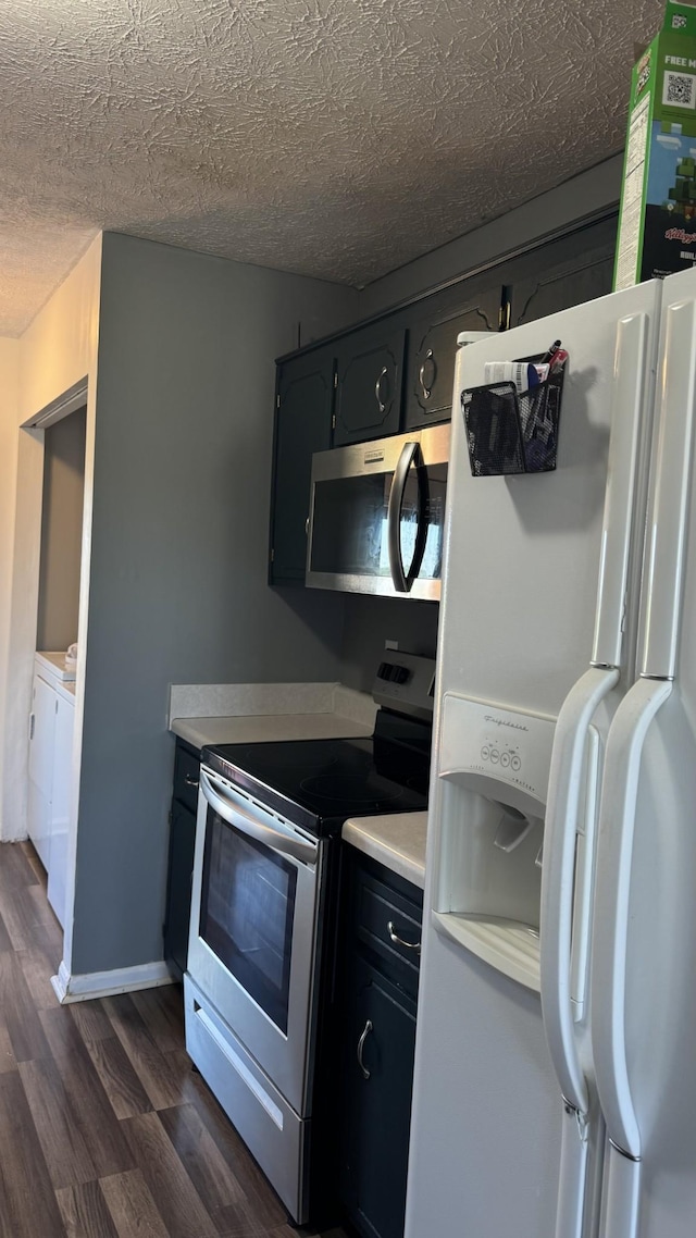 312 Pappy Dr, Oak Grove, KY 42262 - kitchen featuring stainless steel appliances, dark wood-type flooring, separate washer and dryer, light countertops, and a textured ceiling