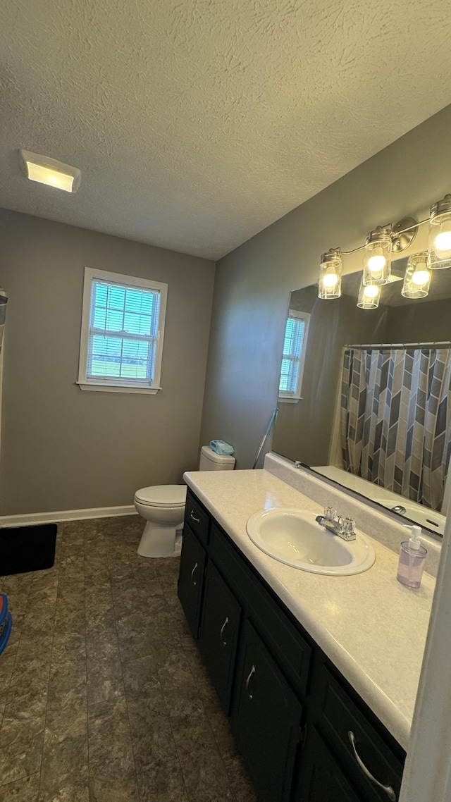 312 Pappy Dr, Oak Grove, KY 42262 - bathroom featuring vanity, toilet, a textured ceiling, a shower with shower curtain, and baseboards