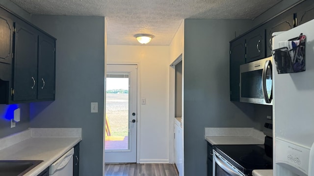 312 Pappy Dr, Oak Grove, KY 42262 - kitchen featuring appliances with stainless steel finishes, a textured ceiling, dark wood-style flooring, and light countertops