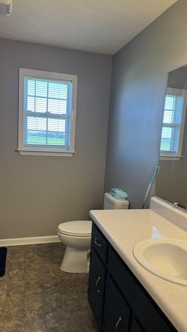 312 Pappy Dr, Oak Grove, KY 42262 - bathroom with toilet, vanity, a textured ceiling, and baseboards