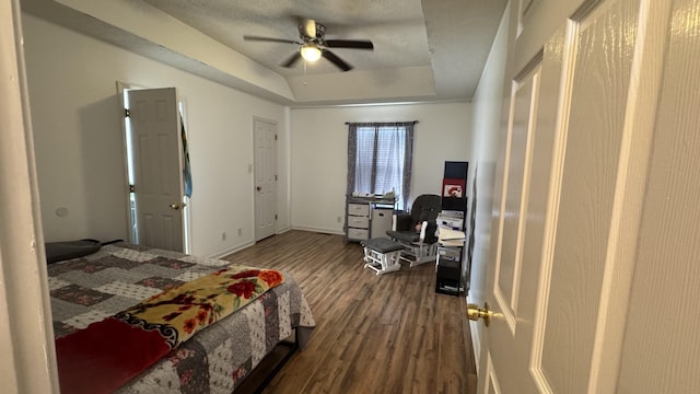 312 Pappy Dr, Oak Grove, KY 42262 - bedroom featuring dark wood-style floors, a tray ceiling, a desk, ceiling fan, and baseboards