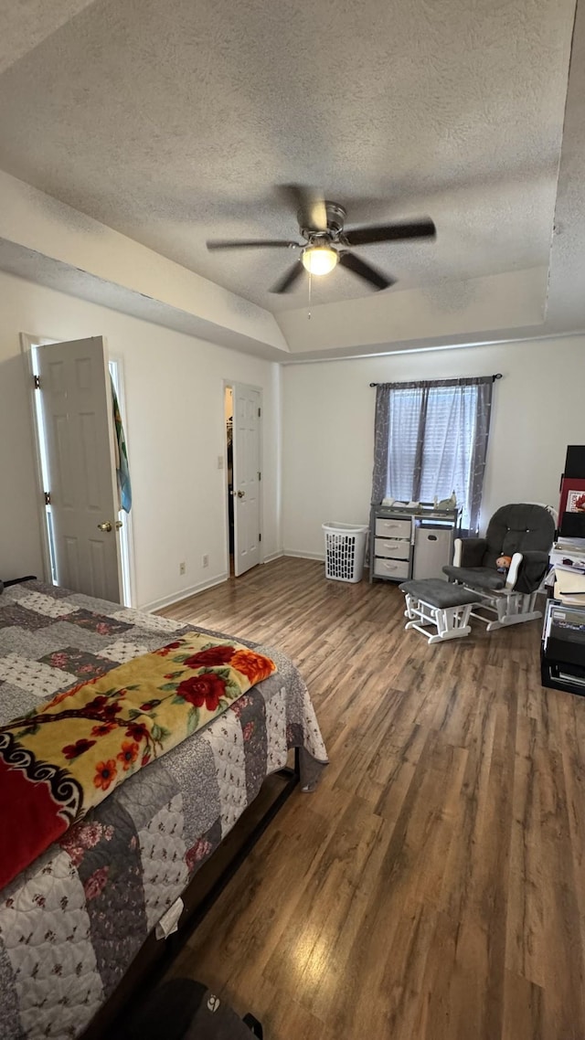 312 Pappy Dr, Oak Grove, KY 42262 - bedroom featuring a textured ceiling, wood finished floors, a tray ceiling, ceiling fan, and baseboards