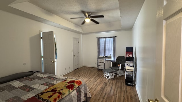 312 Pappy Dr, Oak Grove, KY 42262 - bedroom with a tray ceiling, dark wood finished floors, a textured ceiling, baseboards, and a ceiling fan