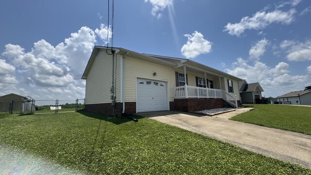 312 Pappy Dr, Oak Grove, KY 42262 - view of property exterior featuring a porch, an attached garage, and concrete driveway