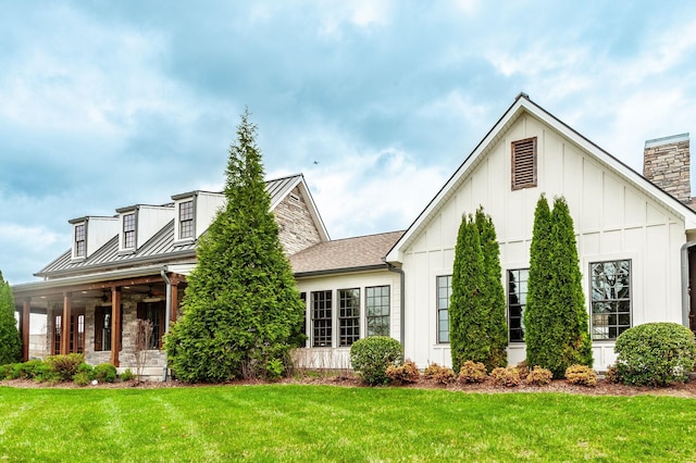 287 Cloverbrook Way, Gallatin, TN 37066 - view of front of home with board and batten siding, a front lawn, a chimney, ceiling fan, and a standing seam roof