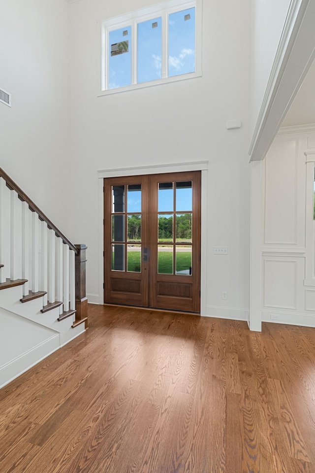 7100 Twelve Corners Rd, Lascassas, TN 37085 - foyer featuring a towering ceiling, stairway, wood finished floors, and baseboards