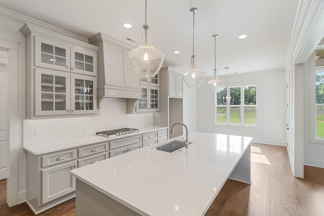 7100 Twelve Corners Rd, Lascassas, TN 37085 - kitchen featuring a sink, stainless steel gas cooktop, a large island with sink, light countertops, and dark wood-style flooring