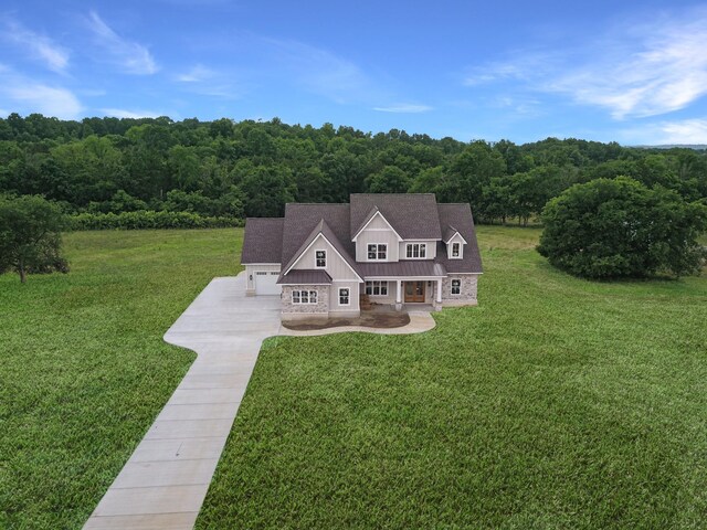 7100 Twelve Corners Rd, Lascassas, TN 37085 - view of front facade with a front yard, board and batten siding, metal roof, a standing seam roof, and a forest view