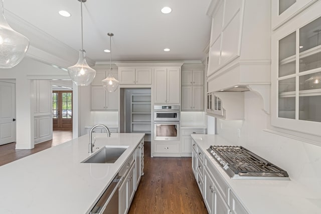 7100 Twelve Corners Rd, Lascassas, TN 37085 - kitchen featuring a sink, appliances with stainless steel finishes, dark wood-type flooring, pendant lighting, and glass insert cabinets