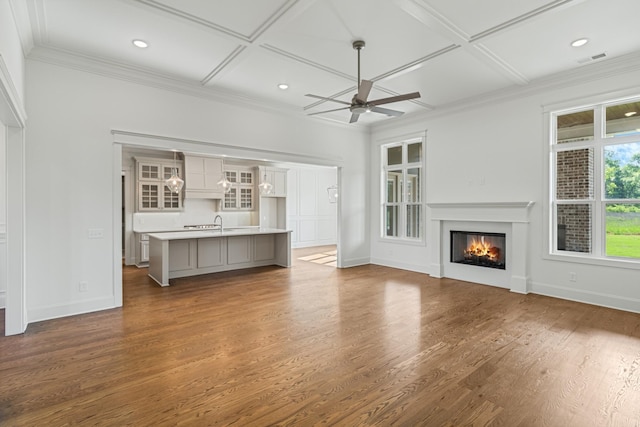 7100 Twelve Corners Rd, Lascassas, TN 37085 - unfurnished living room featuring coffered ceiling, ceiling fan, baseboards, wood finished floors, and a glass covered fireplace