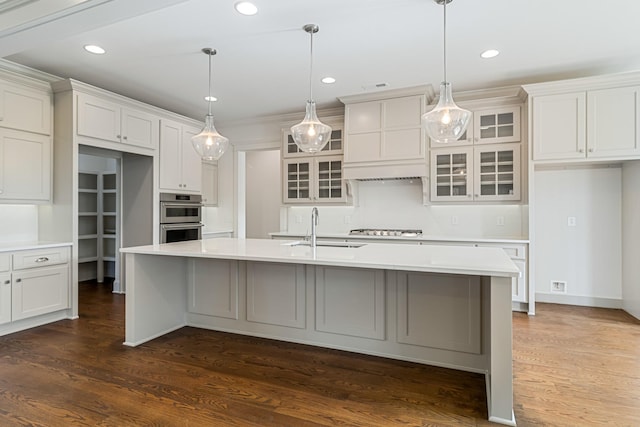 7100 Twelve Corners Rd, Lascassas, TN 37085 - kitchen with a sink, an island with sink, glass insert cabinets, light countertops, and recessed lighting