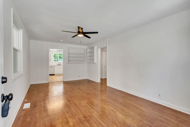 203 Summer St, Mount Pleasant, TN 38474 - unfurnished living room featuring ceiling fan, light wood-style floors, and baseboards