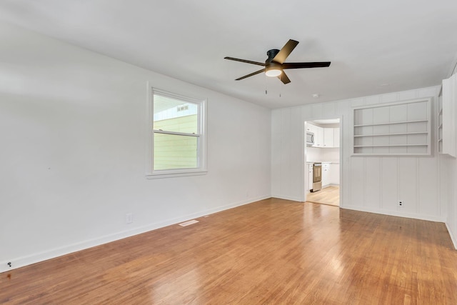 203 Summer St, Mount Pleasant, TN 38474 - spare room with light wood-style floors, ceiling fan, built in shelves, and baseboards