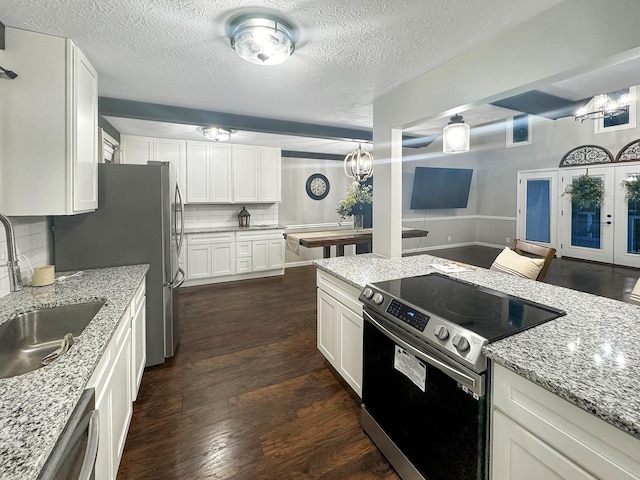 342 Drawbridge Trce, Paducah, KY 42003 - kitchen with stainless steel appliances, tasteful backsplash, dark wood finished floors, white cabinetry, and a textured ceiling