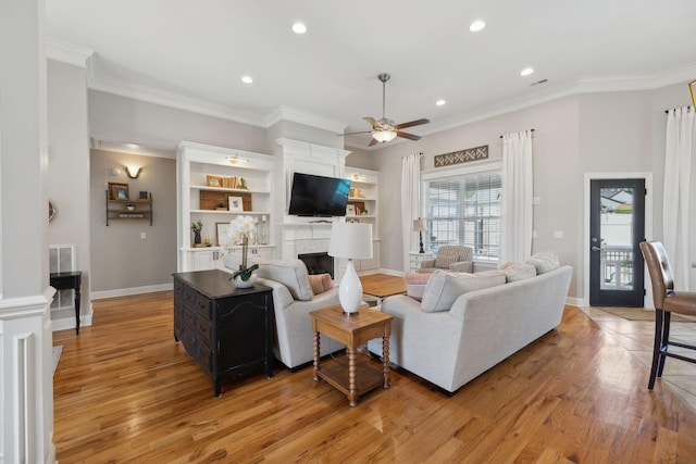 7579 Nightfall Cir, Ooltewah, TN 37363 - living room with light wood-type flooring, a ceiling fan, a fireplace, recessed lighting, and ornamental molding