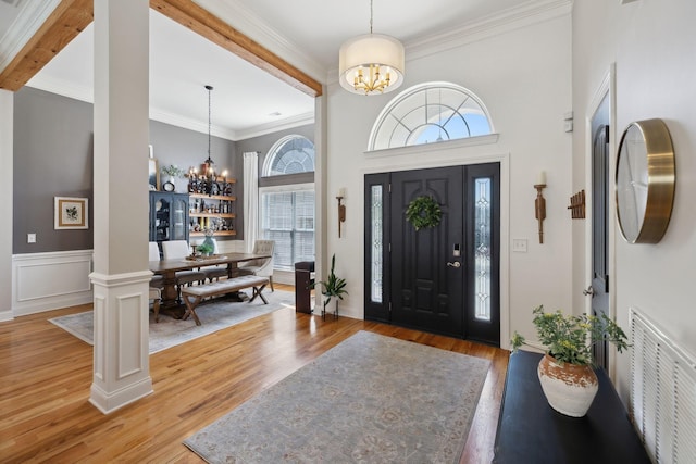 7579 Nightfall Cir, Ooltewah, TN 37363 - foyer featuring a chandelier, healthy amount of natural light, light wood-style floors, crown molding, and a towering ceiling